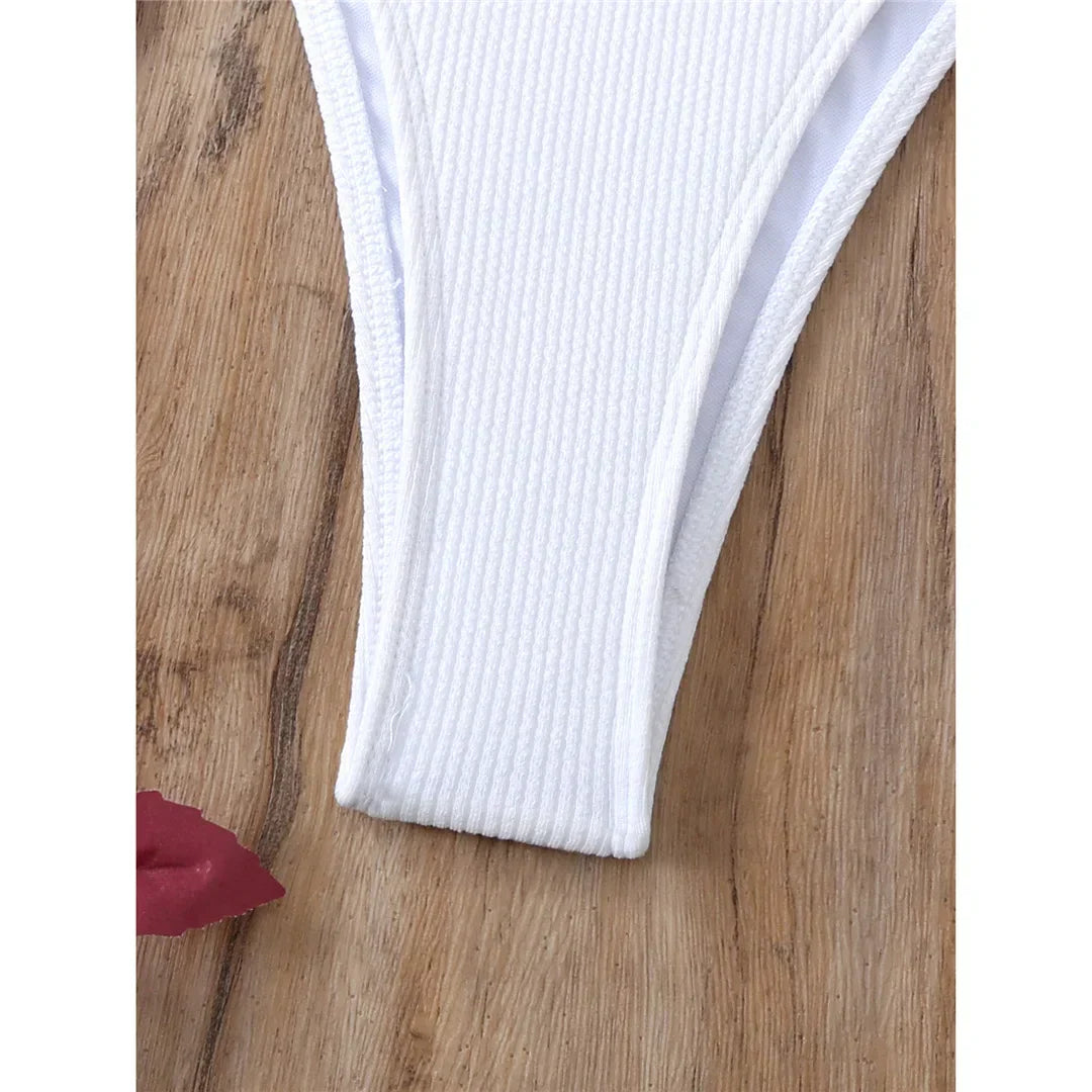 Two-piece swimsuit with ties at the hips and neck.