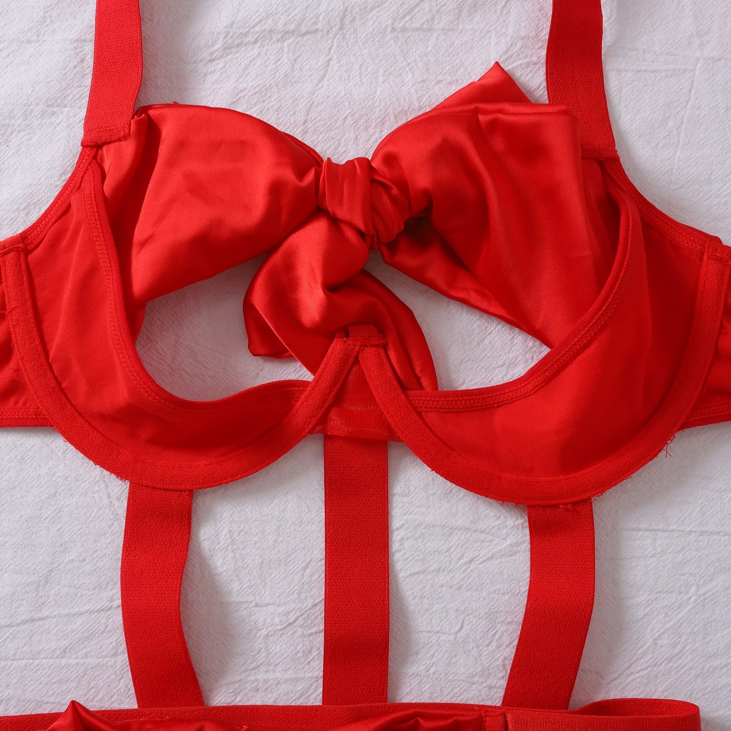 Body with a deep neckline and a bow on the bust.