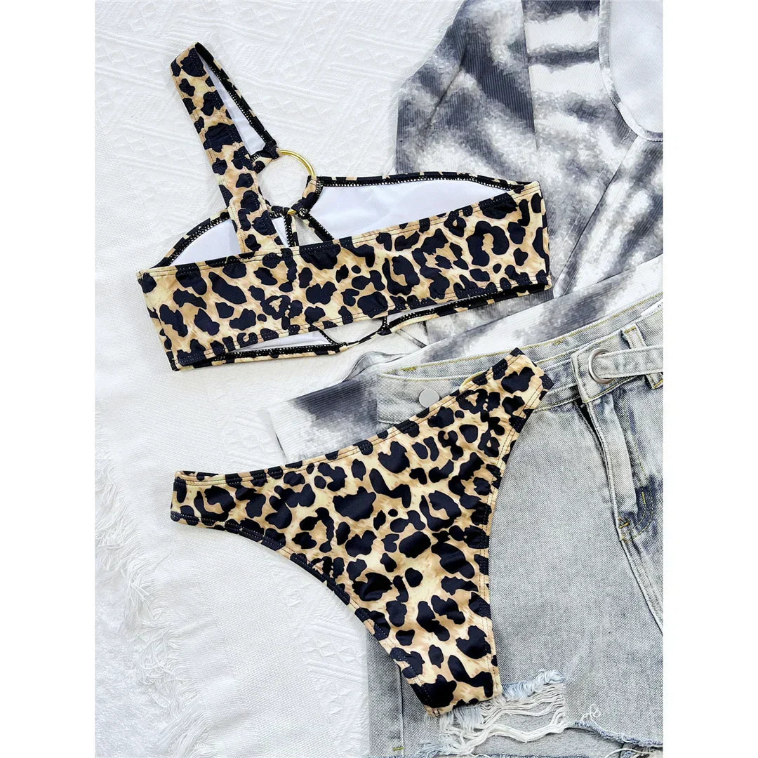 Two-piece leopard print swimsuit with an asymmetrical one-shoulder design.