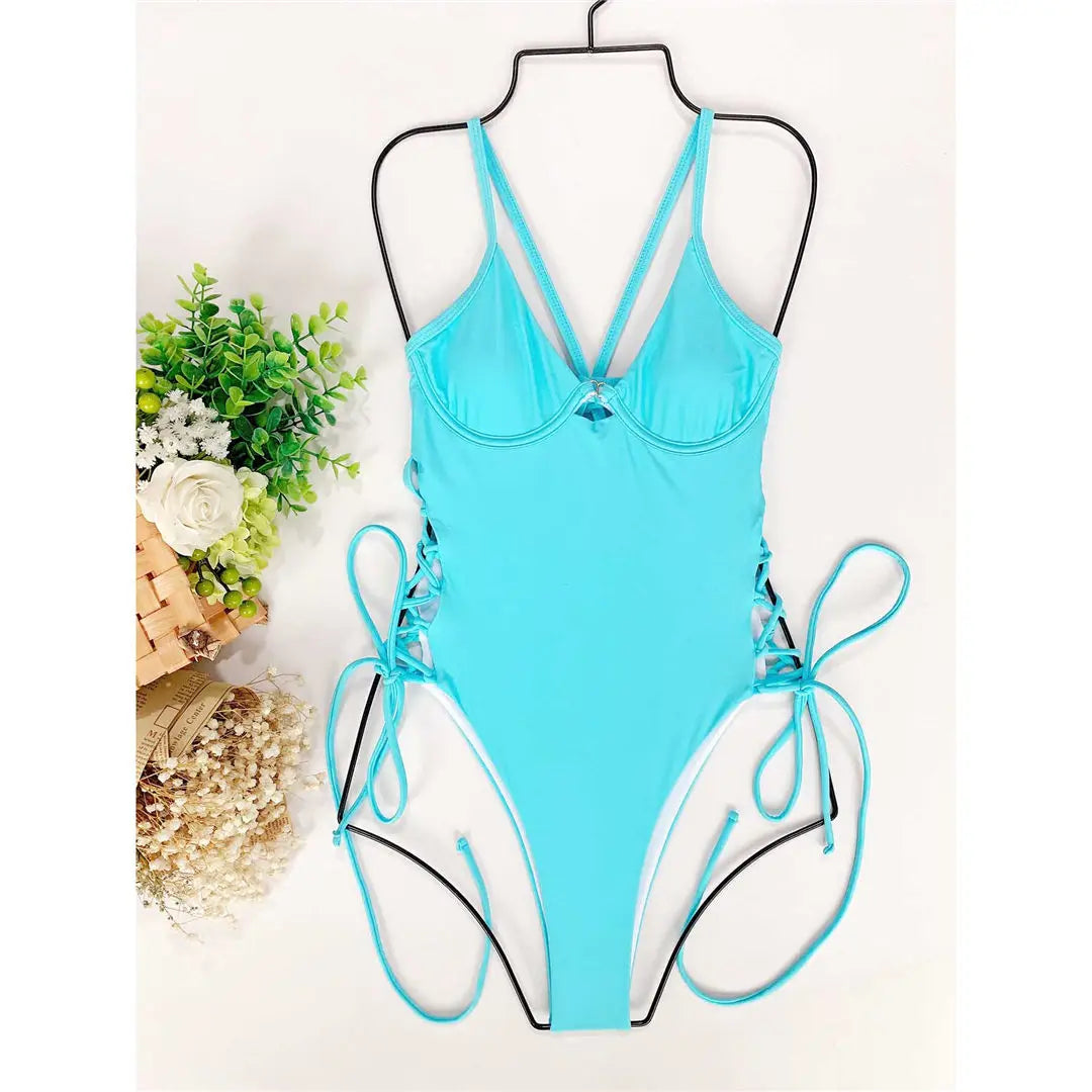 One-piece swimsuit with unique lacing at the hips.