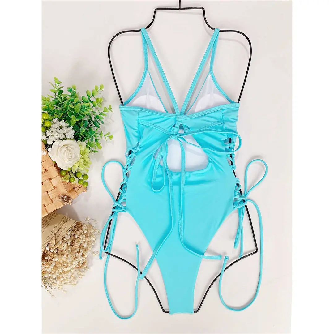 One-piece swimsuit with unique lacing at the hips.