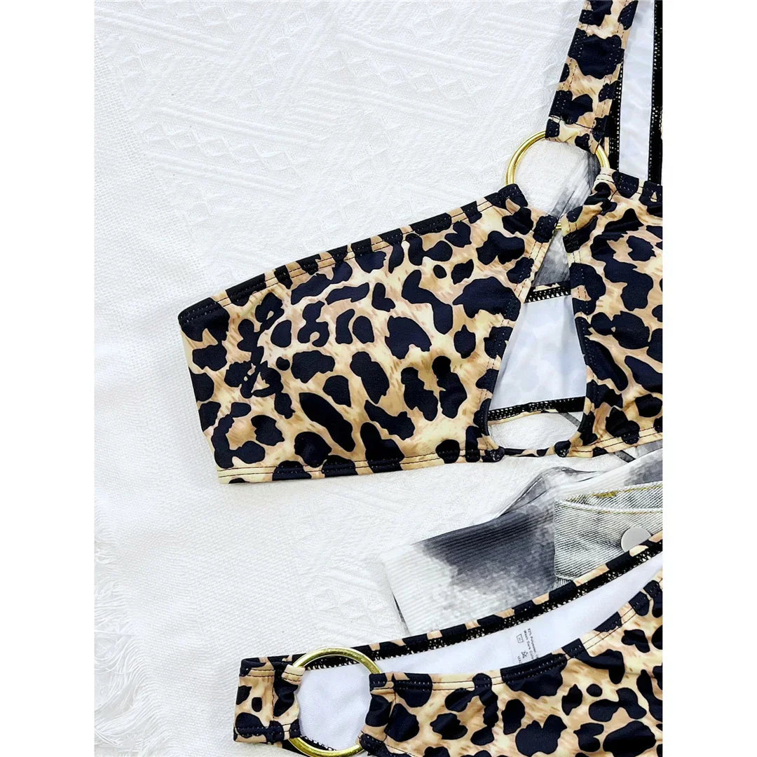 Two-piece leopard print swimsuit with an asymmetrical one-shoulder design.