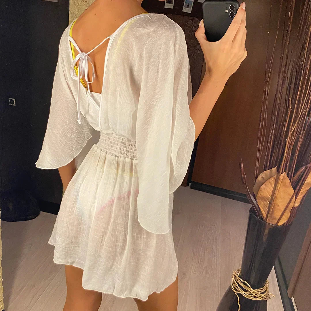 Breezy beach dress with a deep wrap neckline.