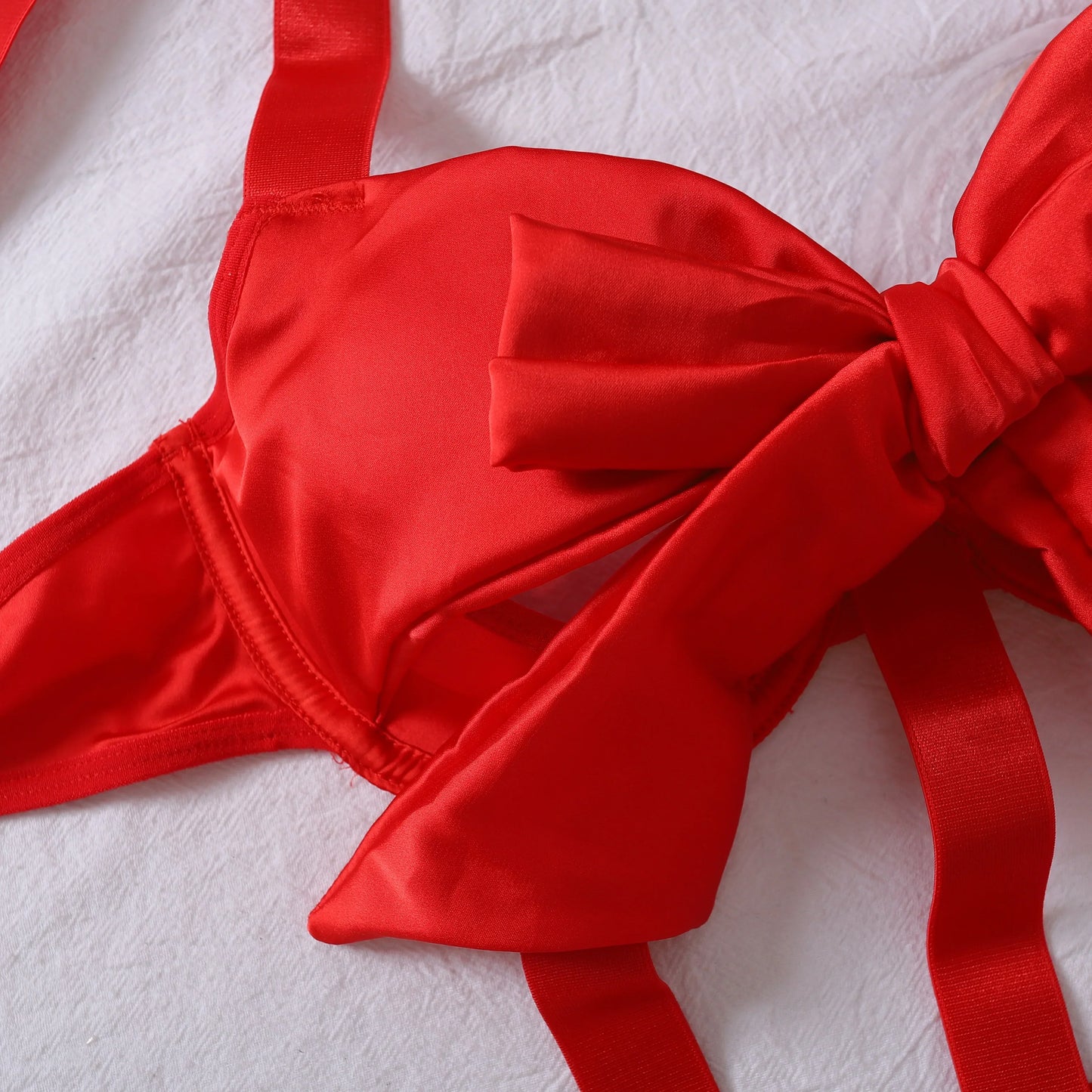 Body with a deep neckline and a bow on the bust.