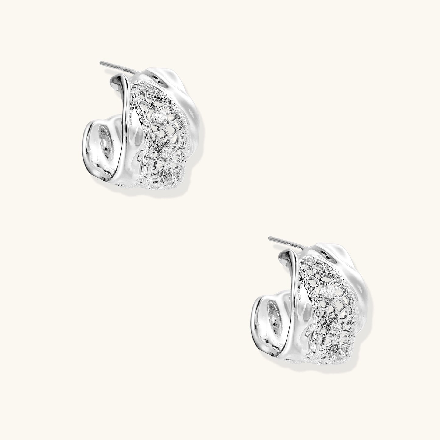 Small gold-plated brass hoop earrings with geometric lattice pattern and zirconia accents on white background.