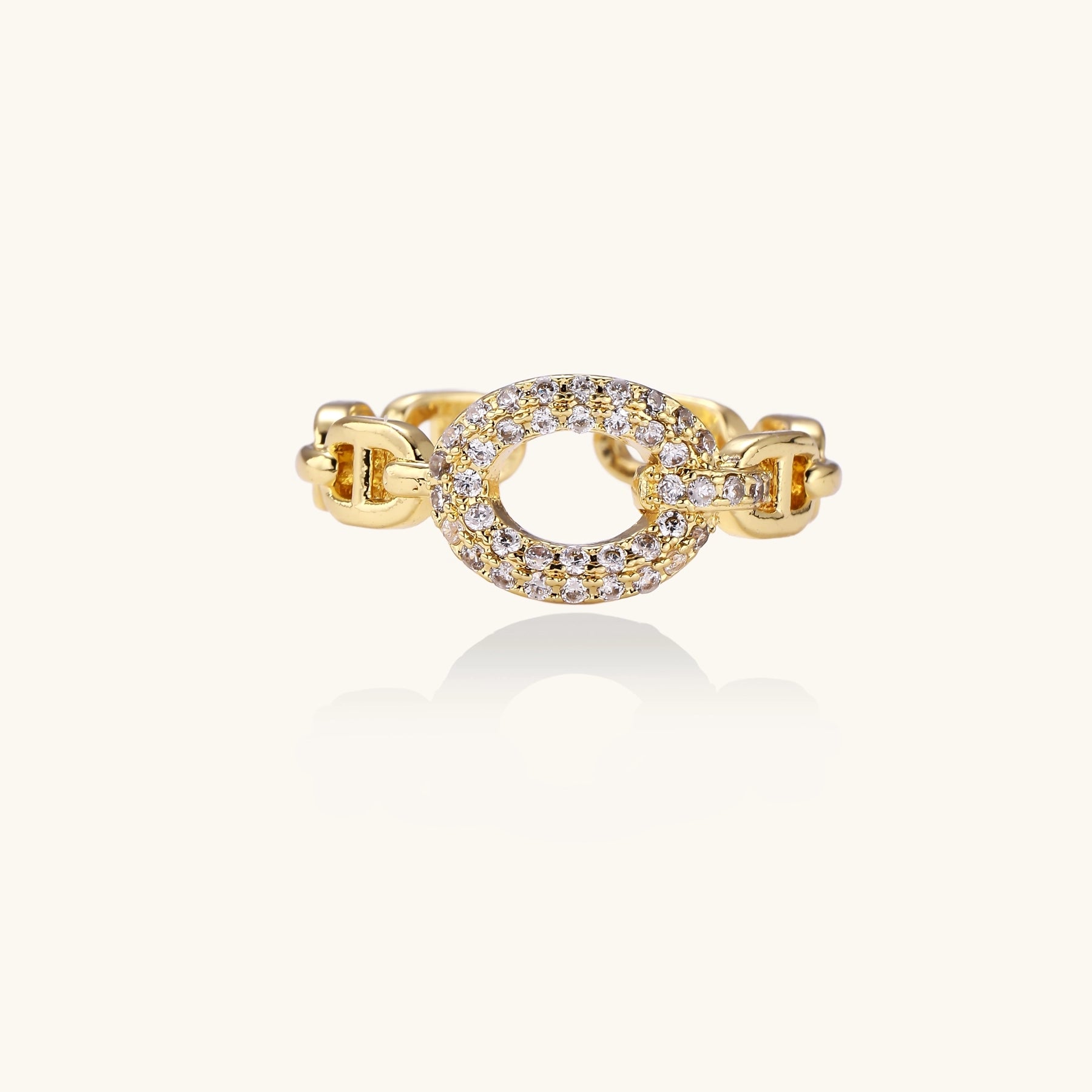 Gold-plated brass chain-link ring with cubic zirconia oval centerpiece, showing adjustable open-back design.