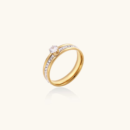 14K gold plated ring with center rhinestone and accent stones along the band on white background.