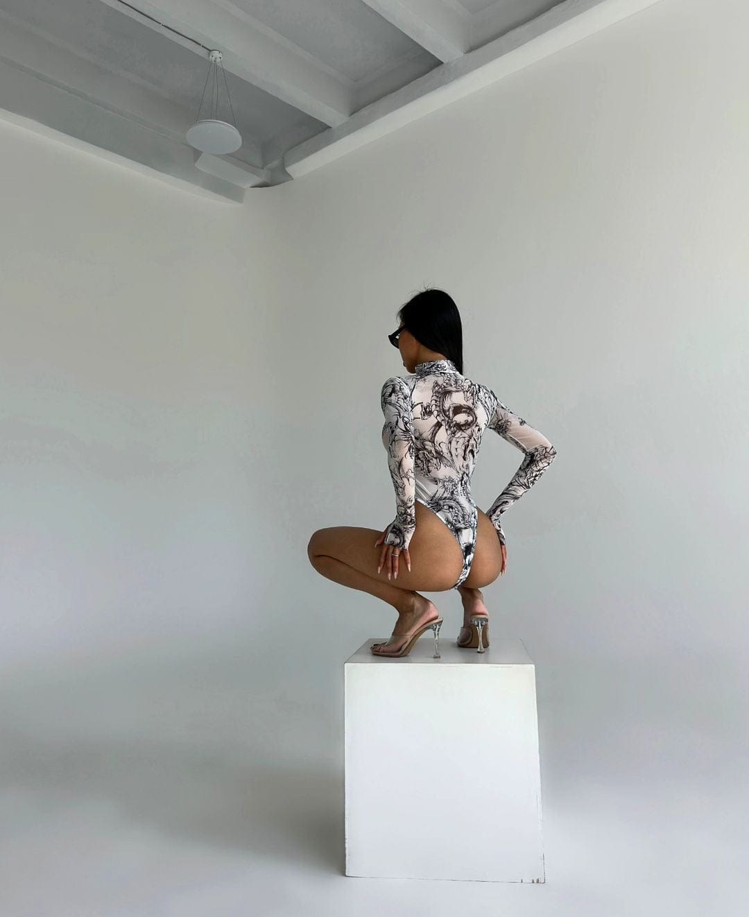 Body made of mesh material with thumb cutouts.