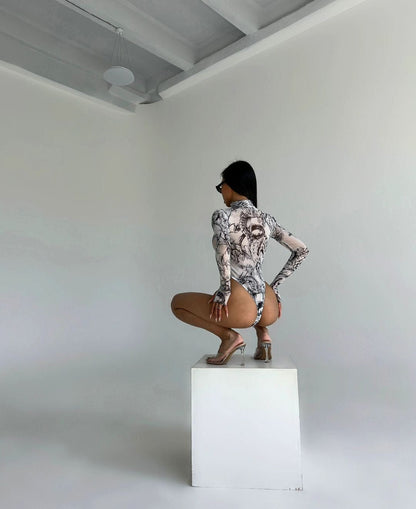 Body made of mesh material with thumb cutouts.