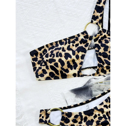 Two-piece leopard print swimsuit with an asymmetrical one-shoulder design.
